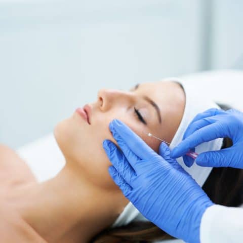 Beautiful young woman getting polydioxanone thread lifting at beauty salon